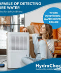 Woman using HydroCheck Smart Water Leak Detector Alarm for home and basement, USA made water sensor next to dehumidifier