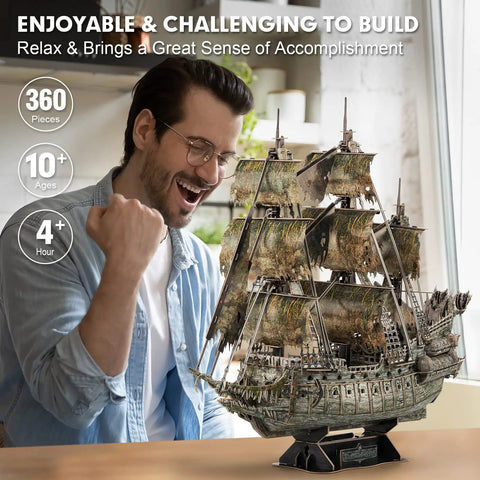 Man celebrating next to LED Flying Dutchman 3D Puzzle for Adults 360 Piece Ship Model Desk Decor for Home Office.