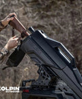 Person placing a rifle into Stronghold Gun Boot L With Autolatch Mount Black Hard Case For Long Guns Up To 52 Inches on ATV