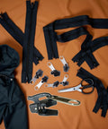 Six Piece Black Universal Zipper Repair Kit With Replacement Teeth And Sliders For Jackets And Bags Easy Install No Brainer Quick Fix Durable Zipper Fasteners Fits Standard Size Zippers For Jackets Bags Backpacks And More displayed with tools and jacket