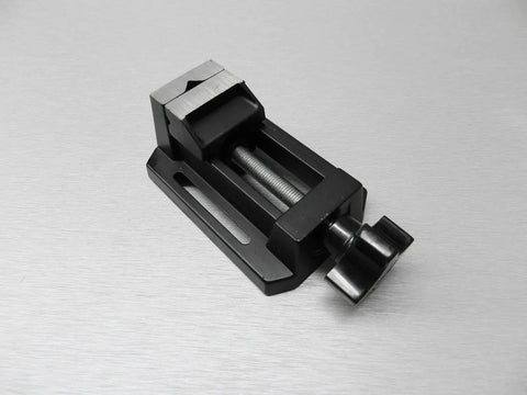 Compact Table Vise For Bench And Drill Press, Mini Precision Vise For Jewelry Hobbyists, Zinc Die Cast Construction, Grips Small Parts With Horizontal And Vertical V Grooves, Mounting Slots With Bolts Washers And Wing Nuts Included on silver surface