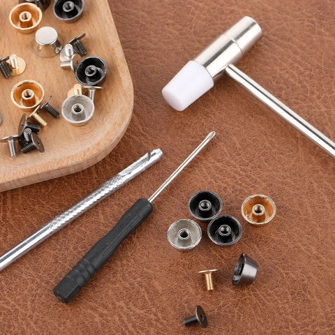 Top Tier Brass Purse Feet For Handbags And Totes - Screw Back Badass Bottom Guards With Punch And Driver Kit Included - assorted brass studs and tools on a work surface