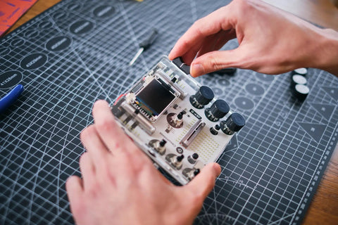 DIY DJ Mixer Kit For Beginners Teens Build Your Own DJ Board Learn Electronics Mix Tracks Add Effects Play Music Via SD Card Kid Friendly STEM Project That Feels Like Real DJing, hands assembling circuit board
