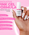 Hand holding bottle of Brush On Nail Glue For Press On Nails With Precision Applicator Pink Gel Adhesive For Artificial And Acrylic Tips