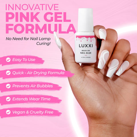 Hand holding bottle of Brush On Nail Glue For Press On Nails With Precision Applicator Pink Gel Adhesive For Artificial And Acrylic Tips
