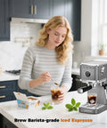 Premium Espresso Coffee Machine With Steam Wand For Cappuccino And Iced Cold Brew Barista Level Shot Pulls Total Coffee Game Changer Smooth Daily Grinds Gray in a kitchen with a woman making iced espresso.
