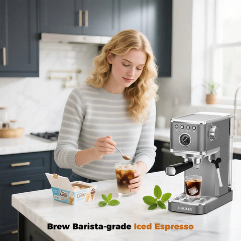 Premium Espresso Coffee Machine With Steam Wand For Cappuccino And Iced Cold Brew Barista Level Shot Pulls Total Coffee Game Changer Smooth Daily Grinds Gray in a kitchen with a woman making iced espresso.