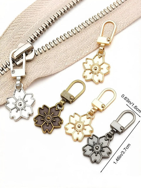 Zipper Pull Replacement Kit With Detachable Tabs, 5 Pcs showing slider and five metallic floral pulls in various colors. Universal fit for backpacks.
