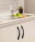10 Pack 5 Inch Matte Black Curved Cabinet Pulls For Kitchen Cupboards and Dresser Drawers with Arch Style Hardware installed on white cabinet.