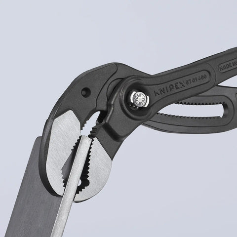 Close-up of Cobra XL Water Pump Pliers gripping a metal sheet, showcasing the hardened teeth and 27-position fine adjustment feature.
