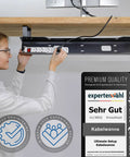 Woman installing under desk cable tray for clean, mess free workspaces, easy cable management organizer to hide cables, sleek black finish