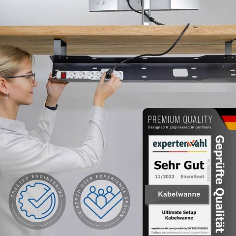 Woman installing under desk cable tray for clean, mess free workspaces, easy cable management organizer to hide cables, sleek black finish