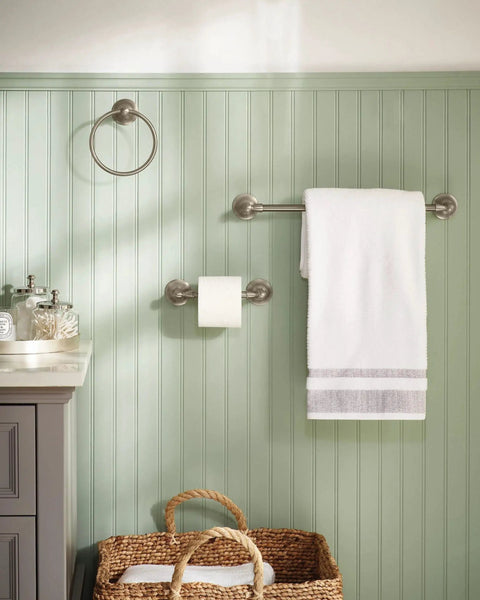 Sage Collection 3 Piece Decorative Bath Hardware Set in Brushed Nickel, wall-mounted in cozy powder room with towel and basket.