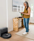 Robot Vacuum With Matrix Clean And Precision Mapping Self Empty Base With 30 Day Capacity Bagless Powerful Pet Hair Cleaning WiFi Enabled Black Renewed in a modern living room.