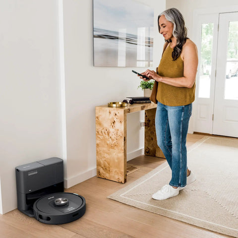 Robot Vacuum With Matrix Clean And Precision Mapping Self Empty Base With 30 Day Capacity Bagless Powerful Pet Hair Cleaning WiFi Enabled Black Renewed in a modern living room.