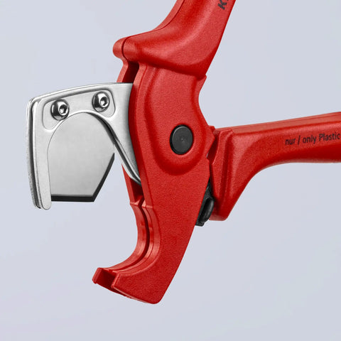 Close-up of red pipe cutter for flexible pipes and hoses up to 1 inch exterior diameter with spring loaded opening and locking lever