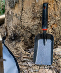 Heavy Duty Ash Shovel For Fire Pits And Grills, Manganese Steel Ember Remover beside tree for outdoor cleanup.