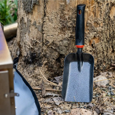 Heavy Duty Ash Shovel For Fire Pits And Grills, Manganese Steel Ember Remover beside tree for outdoor cleanup.