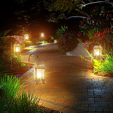 Retro Bronze Metal Solar Lanterns Outdoor Lights Pack Of 2 illuminating a garden path with warm LED glow, vintage style in the dark.