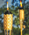 57 Inch Bamboo Tiki Torch Set For Outdoor Patios And Backyards, Natural Woven Torch With Fiberglass Wick And Metal Fuel Canister in use
