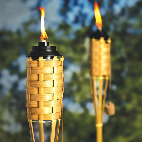 57 Inch Bamboo Tiki Torch Set For Outdoor Patios And Backyards, Natural Woven Torch With Fiberglass Wick And Metal Fuel Canister in use