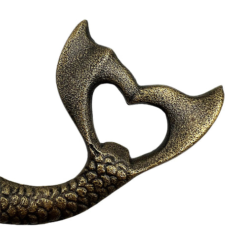 Close-up view of Heavy Duty Cast Iron Mermaid Bottle Opener For Beach House Kitchen Decor, showcasing heart-shaped cap lifter design.