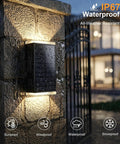Four Pack Solar Wall Lights For Outdoor Use With Dusk To Dawn Sensor mounted on stone wall, showcasing waterproof design.