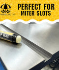 All Purpose Shop Wax Precision Kit Featuring Natural Multi Surface Metal Wood And Plastic Conditioning Paste For Serious Rust Block Smooth Glide And Zero Fuss Grease Free Formula on metal surface near miter slot.