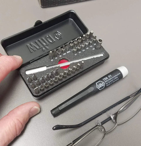 All In One ESD Safe Go Box Micro Bits Set With 39 Pieces Including Slotted Phillips Hex Torx Pentalobe Bits Micro Bit Handle And 100mm Extension shown in black case with user handling