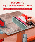 Pneumatic Palm Sander Kit With Random Orbital Action For Auto Body, featuring ergonomic handle on marble surface.