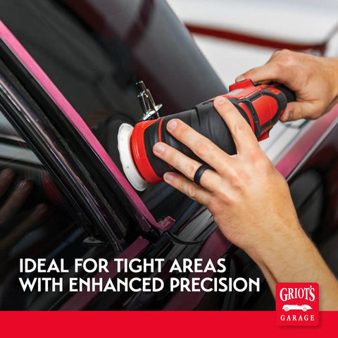 Hands using orbital polisher with 3-inch black foam finishing pad for car polishing and detailing on door frame
