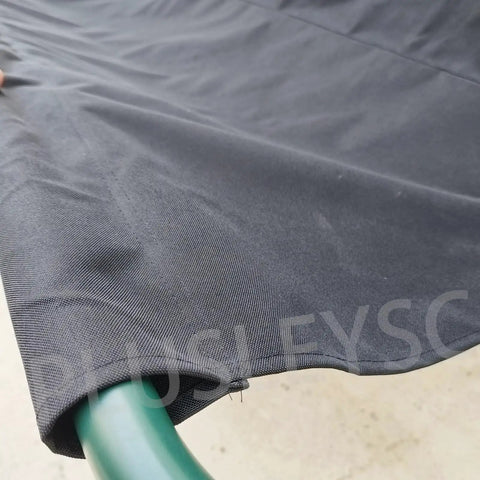 Close-up of black Beefed Up 900D Porch Swing Replacement Fabric for all weather protection, draped over green frame.