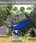 Camping Hammock With Mosquito Net For Outdoor Travel Portable Lightweight Parachute Nylon Hammock With Tree Straps And D Shape Carabiners Breathable Mesh Net Backpacking Ready For Beach Backyard Patio Hiking, shown installed among trees.