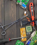 Ultimate 6 Piece Hemostat Set Versatile Locking Clamp Pliers within electronics components on a workbench.