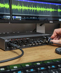 Person adjusting UR44C 6x4 USB 3.0 Audio Interface With D Pre Mic Preamps, 32 Bit 192 kHz Conversion, USB C Connectivity, on desk
