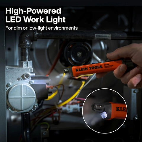 Hand holding high-powered LED work light in dim environment for industrial safety, not a gas leak detector.