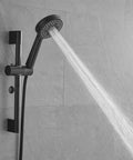 Shower Faucet System, 10-Inch Round Head, 5-Spray Handheld, Matte Black with water spray in modern bathroom setting.
