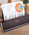 Electric Three Hole Punch for 28 Sheet Capacity with Auto Jam Reverse and Touch Screen Control in use on desk