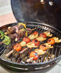 Skewers on the Smokey Joe 14 Inch Portable Charcoal Grill With Tuck N Carry Lid Lock And Durable Porcelain Enamel Finish