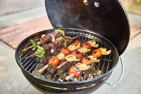 Skewers on the Smokey Joe 14 Inch Portable Charcoal Grill With Tuck N Carry Lid Lock And Durable Porcelain Enamel Finish