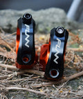 Direct Mount Mountain Bike Stem For 35mm Bars With 2 Piece Split Design in black and orange on a rough surface