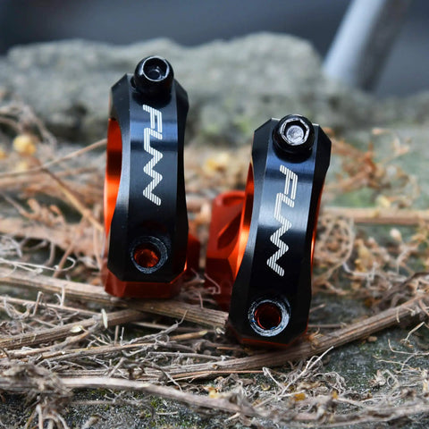 Direct Mount Mountain Bike Stem For 35mm Bars With 2 Piece Split Design in black and orange on a rough surface