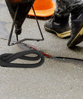 Pro Level Black Foam Backer Rod For Rock Solid Gap Sealing And Expansion Joint Filler With Heavy Duty Closed Cell Structure For Driveways Patios And Concrete Caulking Projects on asphalt with pour spout and worker.