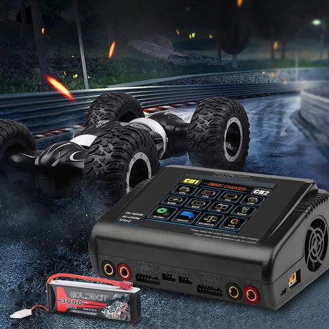 Dual RC Battery Charger With Touch Screen Beefy Power 200W AC Or 400W DC next to RC car and battery on race track