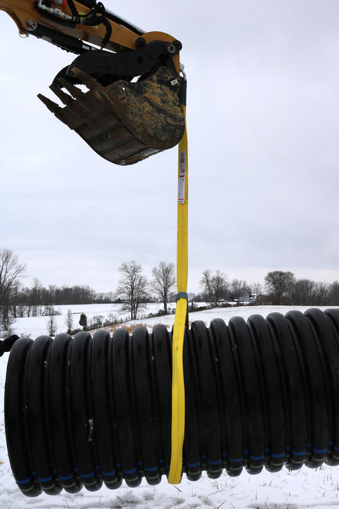 1 Inch by 4 Foot Flat Loop Eye to Eye Lifting Sling with Protective Sleeve in Yellow Polyester lifting heavy pipe outdoors