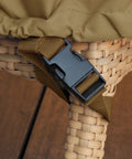 Close-up of Veranda Water Resistant 26 Inch Rectangular Patio Ottoman And Side Table Cover strap on wicker furniture leg