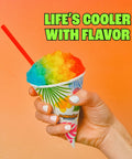 Colorful shaved ice in a cone held by a hand with a straw, showcasing the Sturdy Electric Shaved Ice Machine And Sno Cone Maker For Home That Cracks Cubes Into Powdered Snow Rad Add For Backyard Gatherings And Tailgates Packs Bonus Flavor Syrup Set Hits Different On Hot Days Made In Usa.