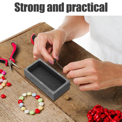 Heavy Lifter Graphite Crucible And Metal Smelting Mold Set With Integrated Oil Traps for jewelry crafting on wooden table.