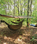 Snakeskin Tarp Sleeve 12ft Camping Rain Fly Storage Kit covering hammock in forest, OD Green, for hiking and backpacking.
