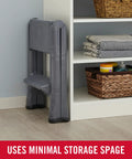 Two Step Folding Foot Stool 14 Inch High Gray Lightweight 300 Pound Capacity folded beside shelf in home